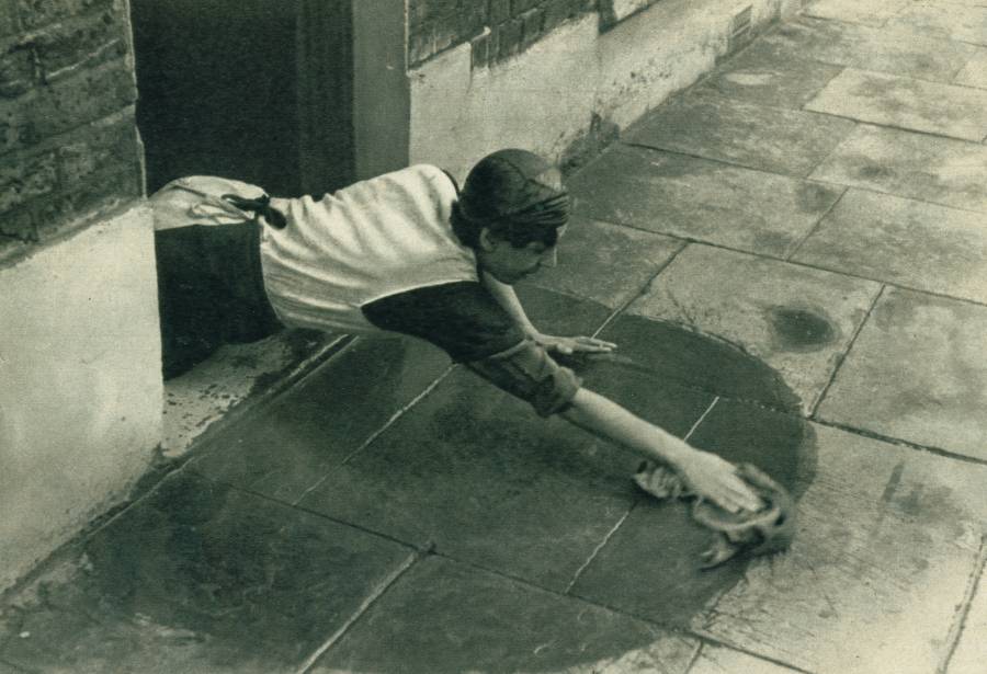 A Lady Cleans Her Doorstep